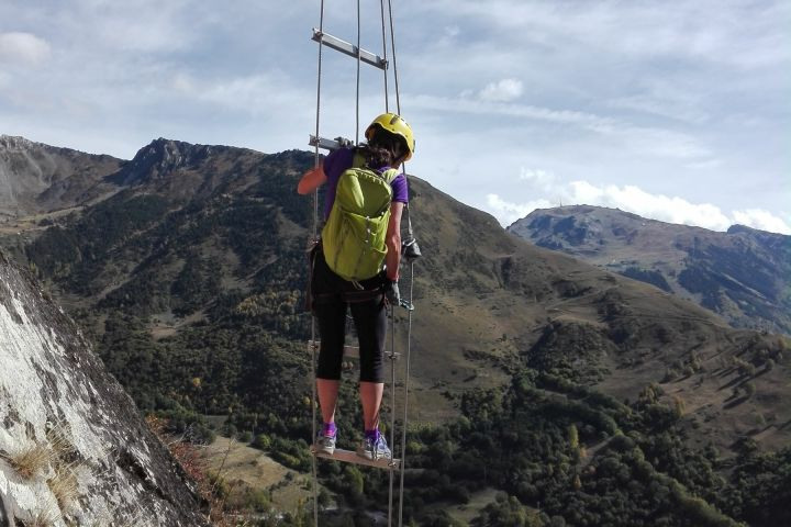 Climbing a via ferrata ladder in the Pyrenees